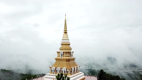 Aerial-view,-Wat-Mon-Pra-Jao-Lai-with-fog-on-the-mountain-in-Chiang-Rai,-Thailand.