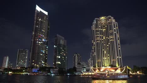 business-district-of-the-metropolis-at-night-on-the-river-bank.-light-in-the-windows-of-offices-of-skyscrapers.-business-center