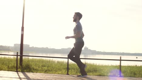 Man-Jogging-on-Riverside-Promenade