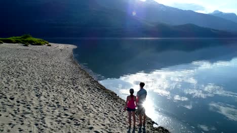 Couple-standing-together-on-lakeshore-4k