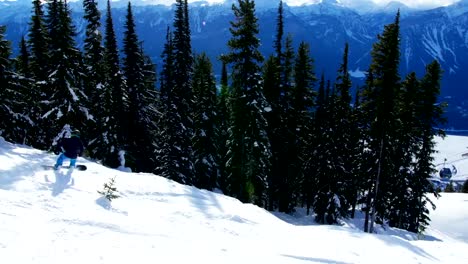 Person-snowboarding-on-snowy-mountain