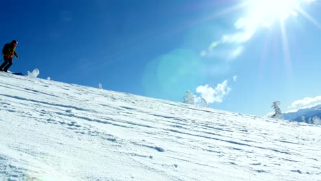 Person-snowboarding-on-snowy-mountain