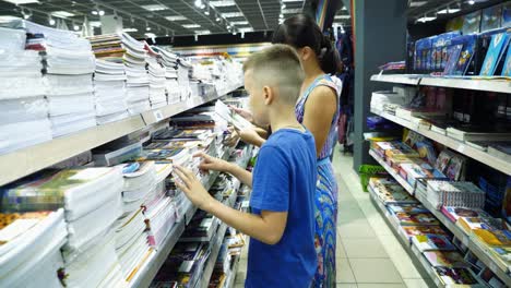 Little-boy-is-buying-stationery-for-school.