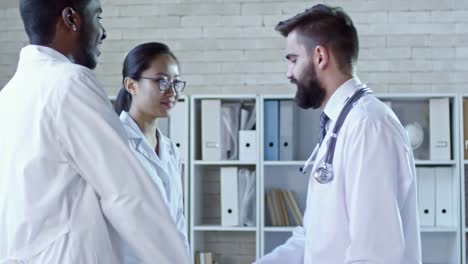 Three-Doctors-Shaking-Hands-before-Meeting