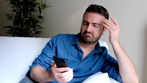 Depressed-man-after-reading-message-on-the-phone