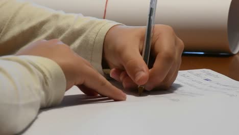 hand-of-left-handed-boy-writing-school-homework