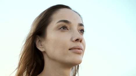 Woman-looking-up-into-the-sky.-Portrait-of-a-pensive-girl.