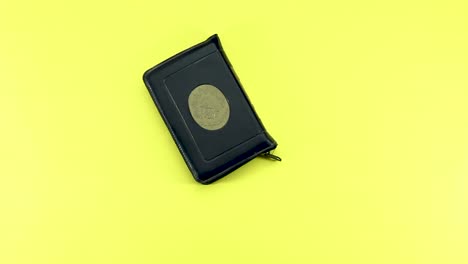 woman-hand-putting-holy-book-of-muslims-and-rosary,-siwak,-perfume-on-yellow-background