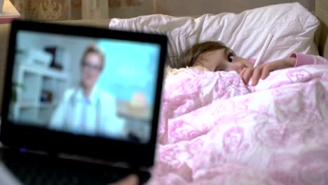 Mom-with-a-little-sick-daughter-gets-a-doctor's-consultation-using-video-chat-at-home.