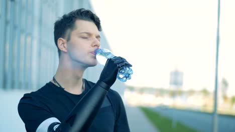 Physically-challenged-man-is-drinking-water-using-his-futuristic-bionic-hand.