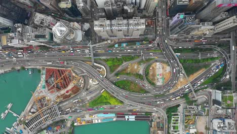 downtown-bay-traffic-road-junction-construction-victoria-harbour-aerial-topdown-panorama-4k-hong-kong