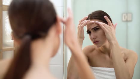 Problem-Skin.-Woman-Crushing-Spot-On-Face-And-Looking-In-Mirror