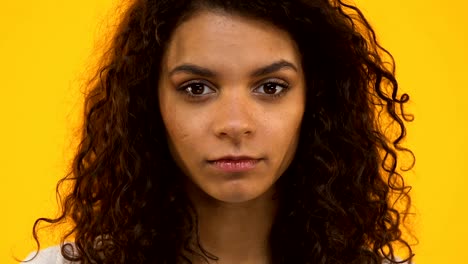 Biracial-girl-holding-stop-sign,-protesting-bullying-or-racism,-gun-violence