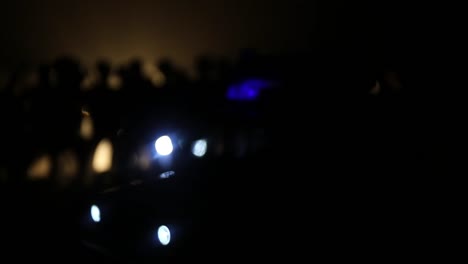 Anti-riot-police-give-signal-to-be-ready.-Government-power-concept.-Police-in-action.-Smoke-on-a-dark-background-with-lights.-Blue-red-flashing-sirens.-Dictatorship-power