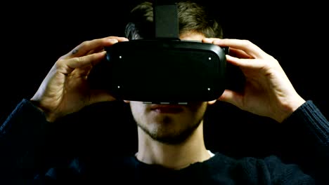 young-nice-man-using-3d-reality-in-life-with-oculus-and-augmented-reality-technology-with-implements-of-reality.