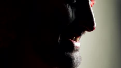 Evil-smile-on-frightening-face-of-scary-clown-at-Halloween,-mouth-closeup