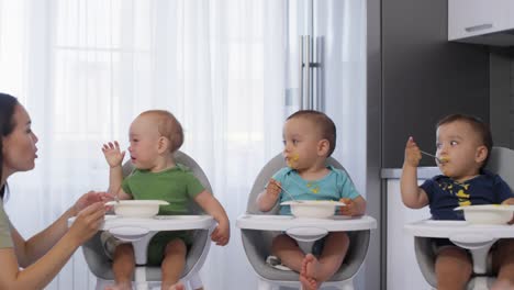 Asian-Triplets-in-High-Chairs-Eating-Lunch