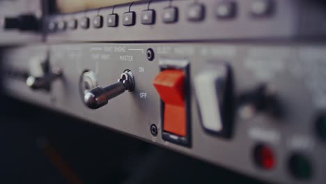 Female-hand-switch-toggle-on-airplane-control-pane.-Control-buttons