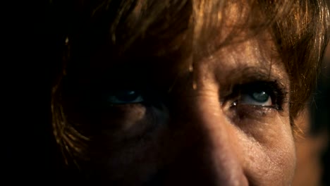 Depressed-sad-mature-woman's-blue-eyes-opening