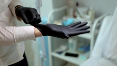 Beautician-putting-on-rubber-glove-on-her-hand.