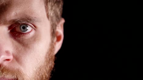 Serious-look-of-a-young-man-in-a-studio-on-a-black-background