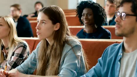 In-the-Classroom-Multi-Ethnic-Students-Listening-to-a-Lecturer-and-Writing-in-Notebooks.-Smart-Young-People-Study-at-the-University.