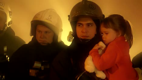 Firefighters-with-rescued-child