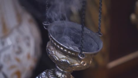 Smoking-device-in-the-middle-of-the-ritual.-Close-up-slow-motion-footage-of-a-smoking-device-in-the-middle-of-the-ritual-in-the-middle-of-the-church