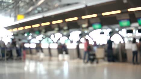 Blurred-footage-of-passengers-walking-to-check-in-counter-at-International-airport-terminal.-4K-video-with-defocused-effect.