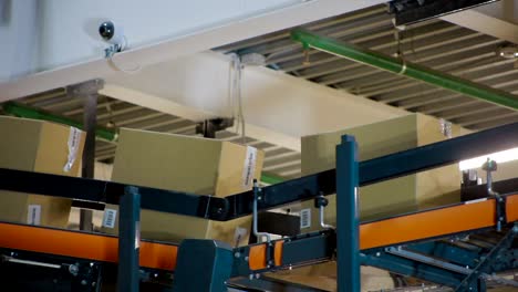 Cardboard-boxes-on-conveyor-belt-inside-warehouse