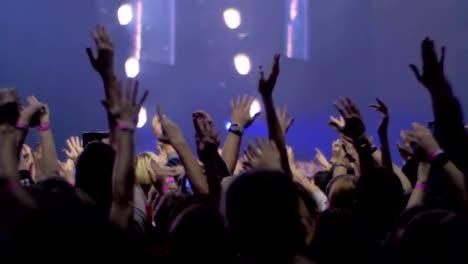 People-with-hands-up-at-the-rock-concert,-view-with-stage-lights