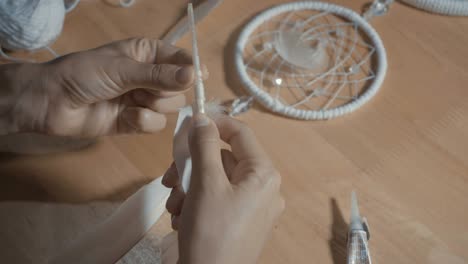 Female-Hands-Creating-Dream-Catcher-Closeup