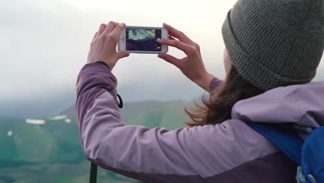 Woman-taking-photograph-smartphone-sharing-photo-of-landscape-nature-background-enjoying-vacation-holiday-travel-adventure