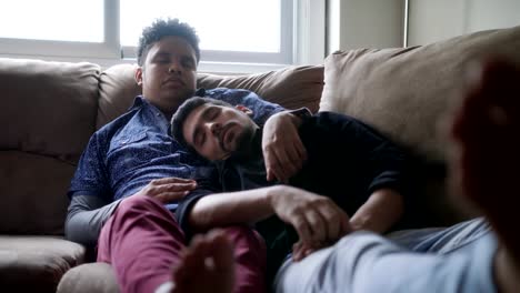 Young-Gay-Men-Sleeping-And-Relaxing-On-Sofa-At-Home