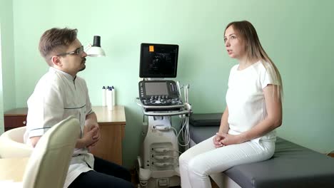 Doctor-and-patient-sitting-and-talking-in-ultrasound-diagnostic-room.