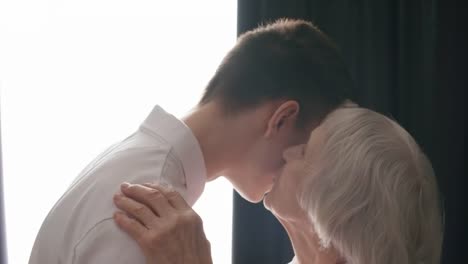 Loving-Grandmother-Hugging-and-Kissing-Grandson