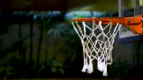 People-training-basketball-free-throw.-Basketball-net-close-up.-Flat-plane.-Side-view