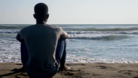 Missing-mother-Africa.-lonely-black-migrant-looking-at-the-ocean-thinking-Africa