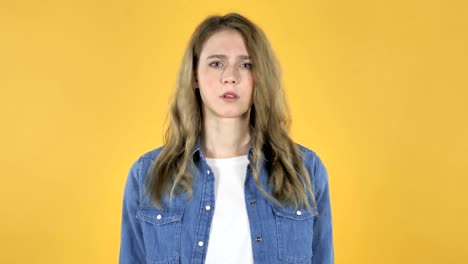 Young-Pretty-Girl-Waving-Finger-to-Refuse-on-Yellow-Background