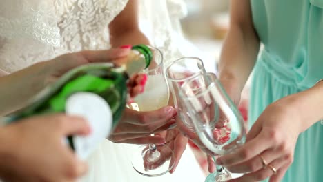 Close-up-of-the-girl-poured-champagne-into-glasses-at-a-bachelorette-party.