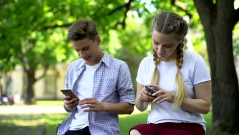 Gadget-süchtig-Freunde-mit-Handys-in-Park,-Mangel-an-Kommunikation,-ignorieren