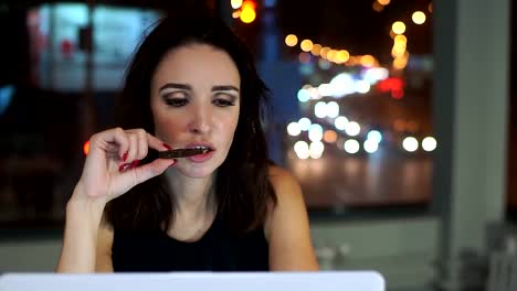 Woman-working-late-at-the-laptop,-eating-cookies.