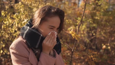 Sick-girl-sneezing-outdoor.