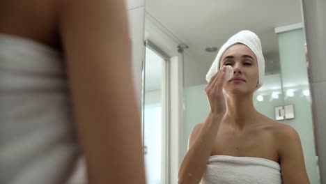 Skin-Care.-Woman-Cleaning-Face-With-Lotion-At-Bathroom