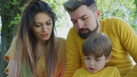 Young-parents-reading-to-their-child