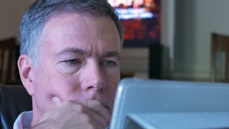 man-sitting-and-using-a-tablet-pc