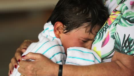 Kid-cries-and-weeps.-Authentic-candid-child-crying-in-grand-mother-arms