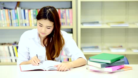 Study-hard-in-library.-Young-Chinese-girl-study-hard-at-library.