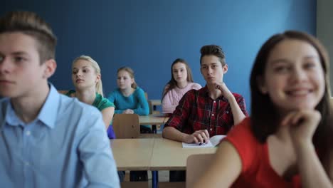 students-with-notebooks-on-lesson-at-school