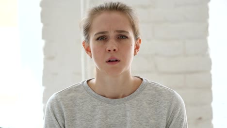 Sad-Casually-Sitting-Young-Woman-in-Office